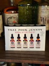 Load image into Gallery viewer, View on liquor cabinet shelf. Five miniature bottles of Free Pour Jenny's bitters from the Yukon Territory, contained in the new Boreal Bitters Mini Set. Perfect for gifting. Orange, Labrador Tea & Lime, Fireweed, Spruce Tip, Solstice. wild foraged, home bar, gift ideas, small batch, gift set, bartender, handmade, cocktails, recipes